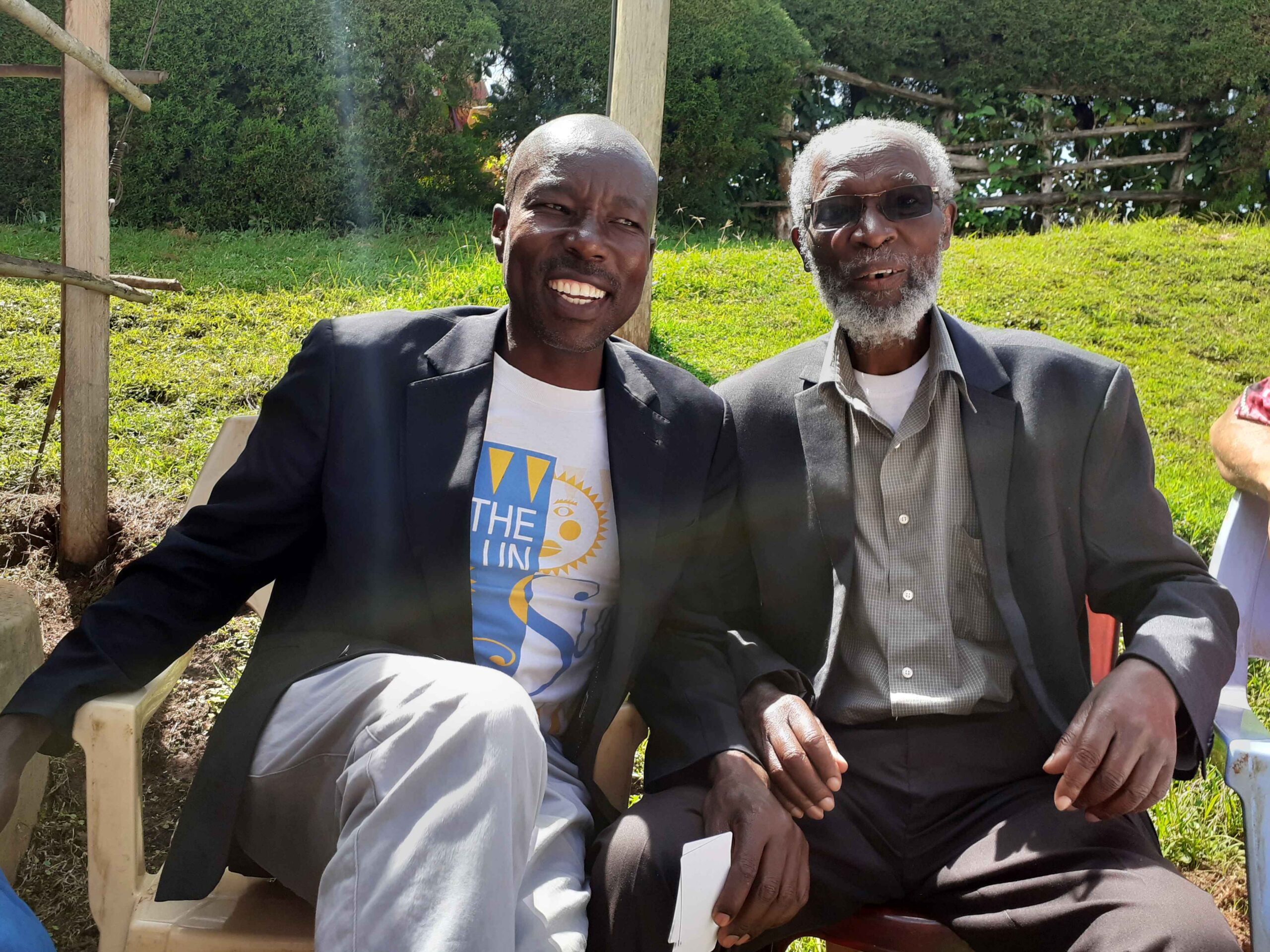 Elkana On'gesa and nephew Peter Kenyanya, a noted sculptor, pose for a photo in November 2022.